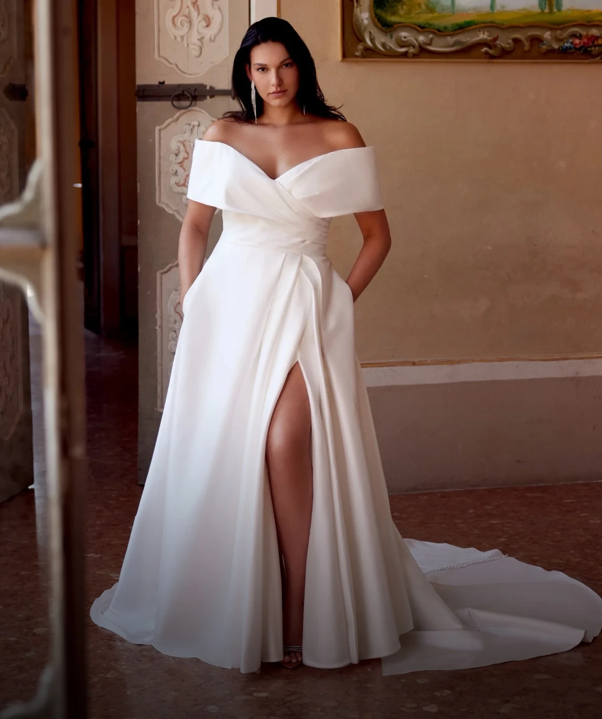 Plus size model wearing a white gown